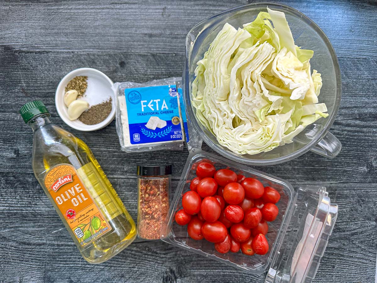 recipe ingredients - spices, garlic, feta, olive oil, hot pepper flakes, tomatoes and cabbage
