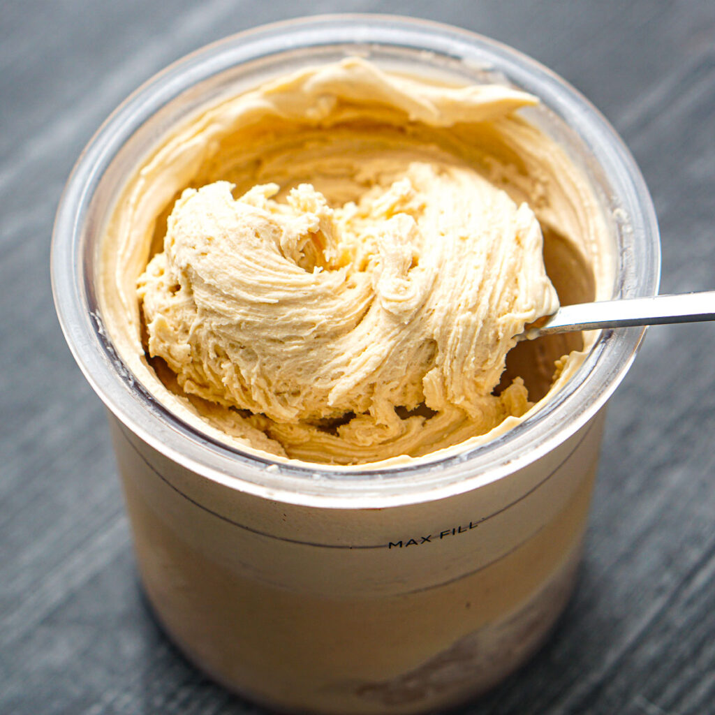 a spoon in a pint container or peanut butter Ninja Creami protein ice cream