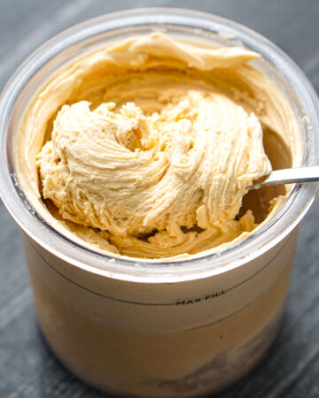 a spoon in a pint container or peanut butter Ninja Creami protein ice cream
