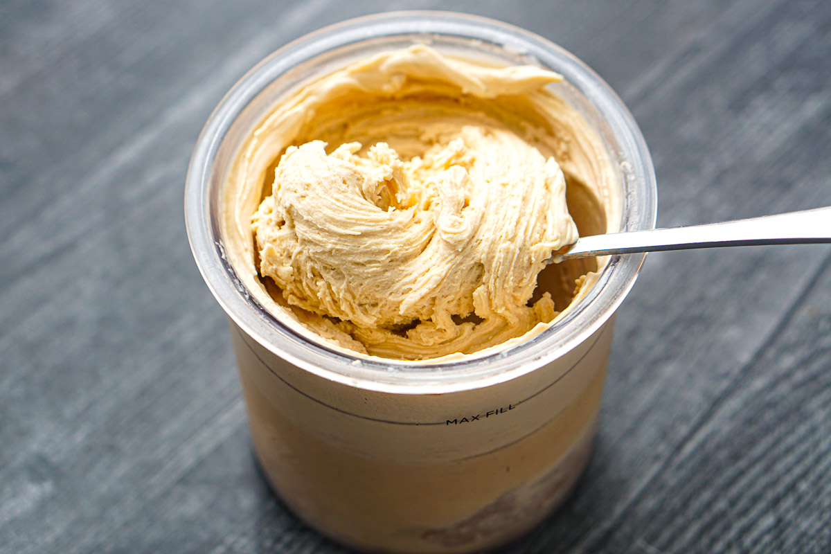 a spoon in a pint container or peanut butter Ninja Creami protein ice cream