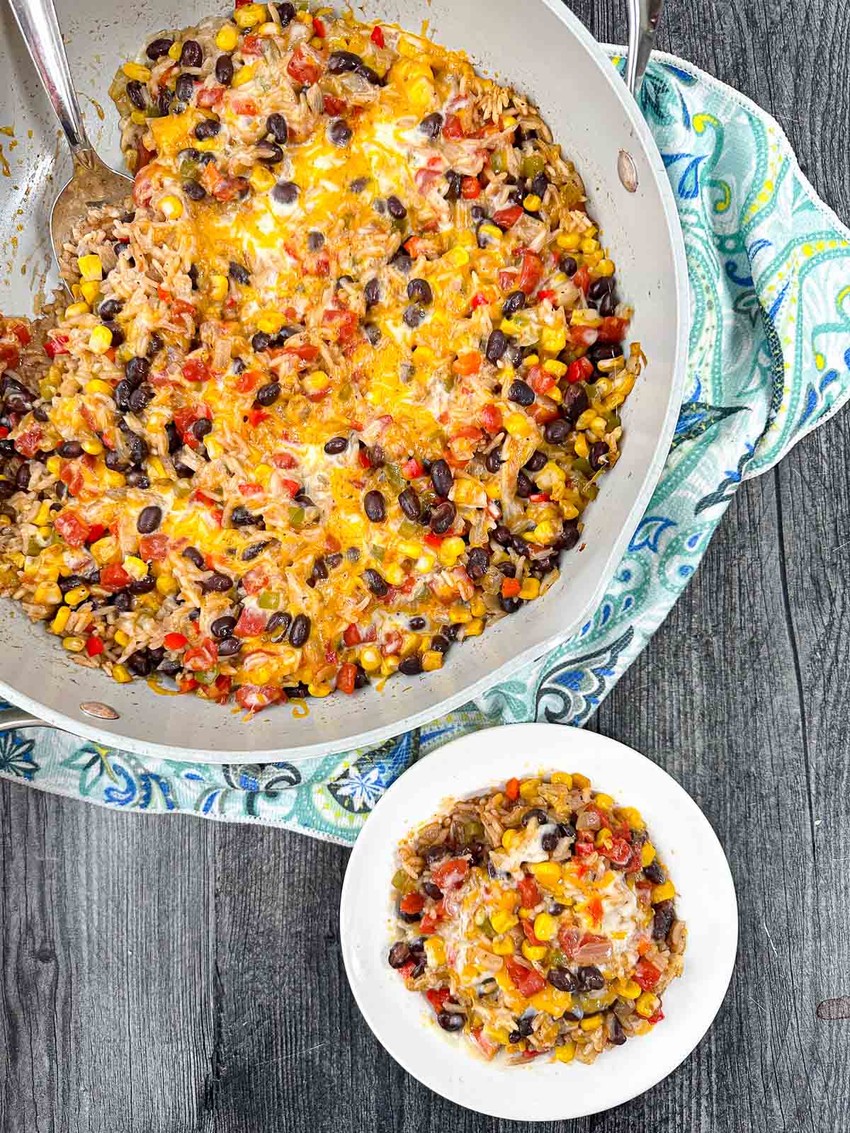 aerial view of a white plate and pot with Mexican rice casserole