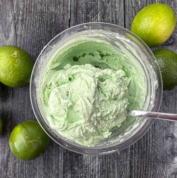 aerial view of a pint container with Ninja cream keto lime ice cream and few fresh limes