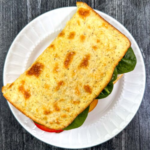 white plate with keto cottage cheese flatbread sandwich