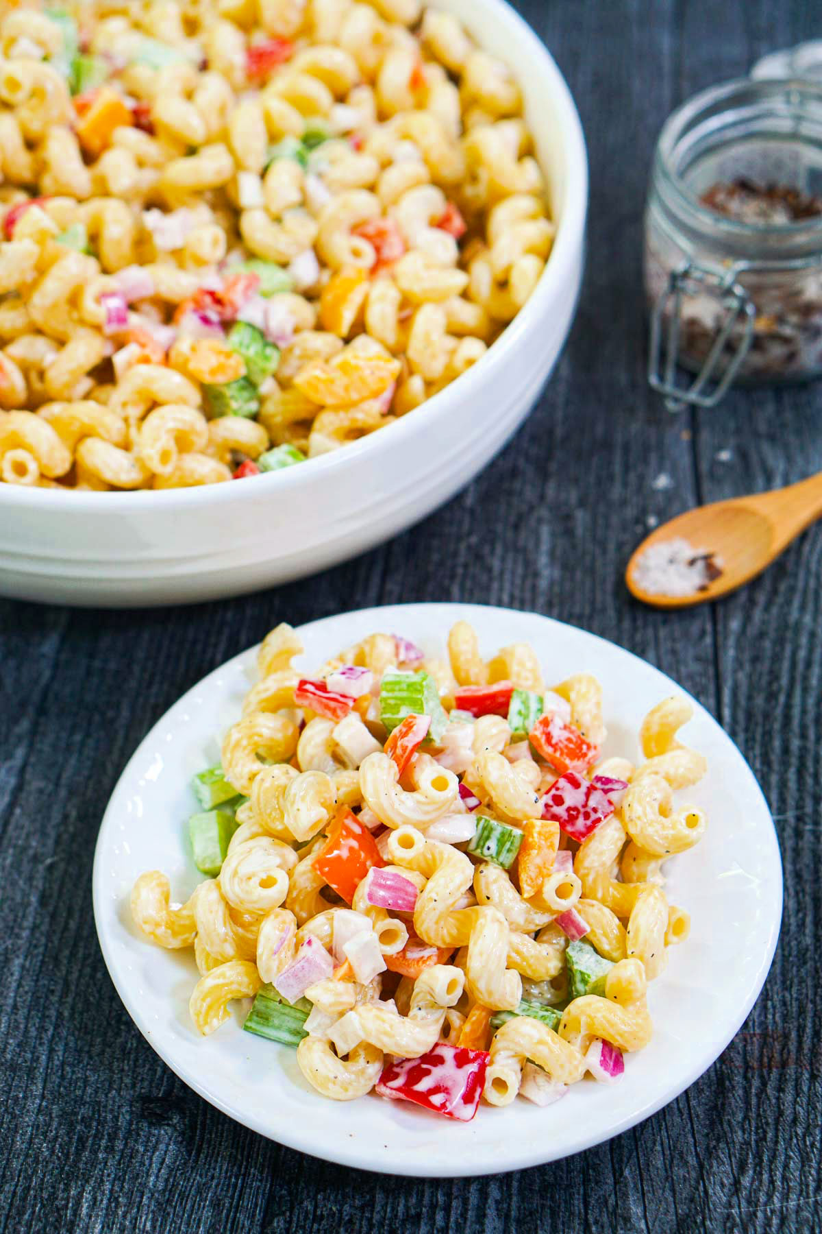 white bowl and plate with pasta salad with creamy dressing