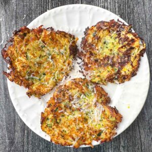 white plate with 3 low carb zucchini latkes