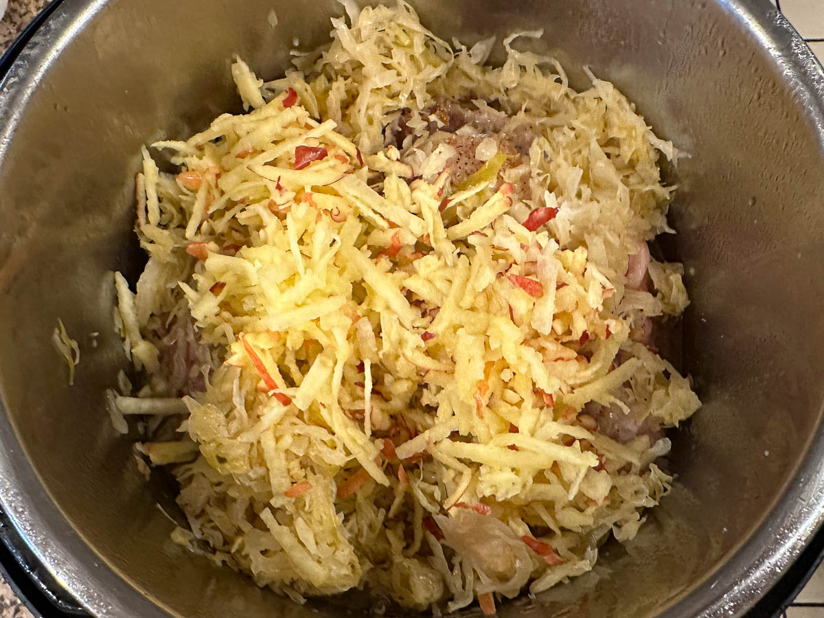 The additional of grated apples to the pot.