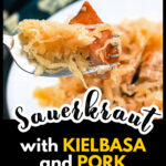 Closeup of a forkful of New Year's pork and sauerkraut with kielbasa and text overlay.
