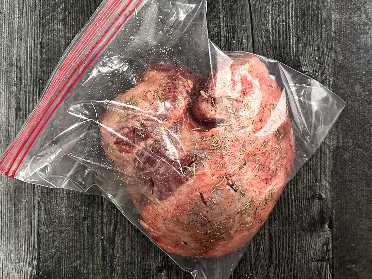 Bag with raw roast stuffed with garlic and spices.