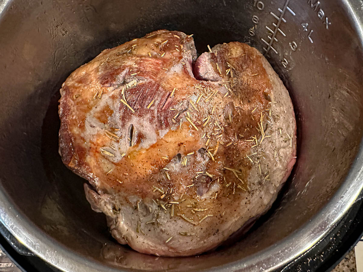 Closeup of a the browned roast in the pressure cooker.