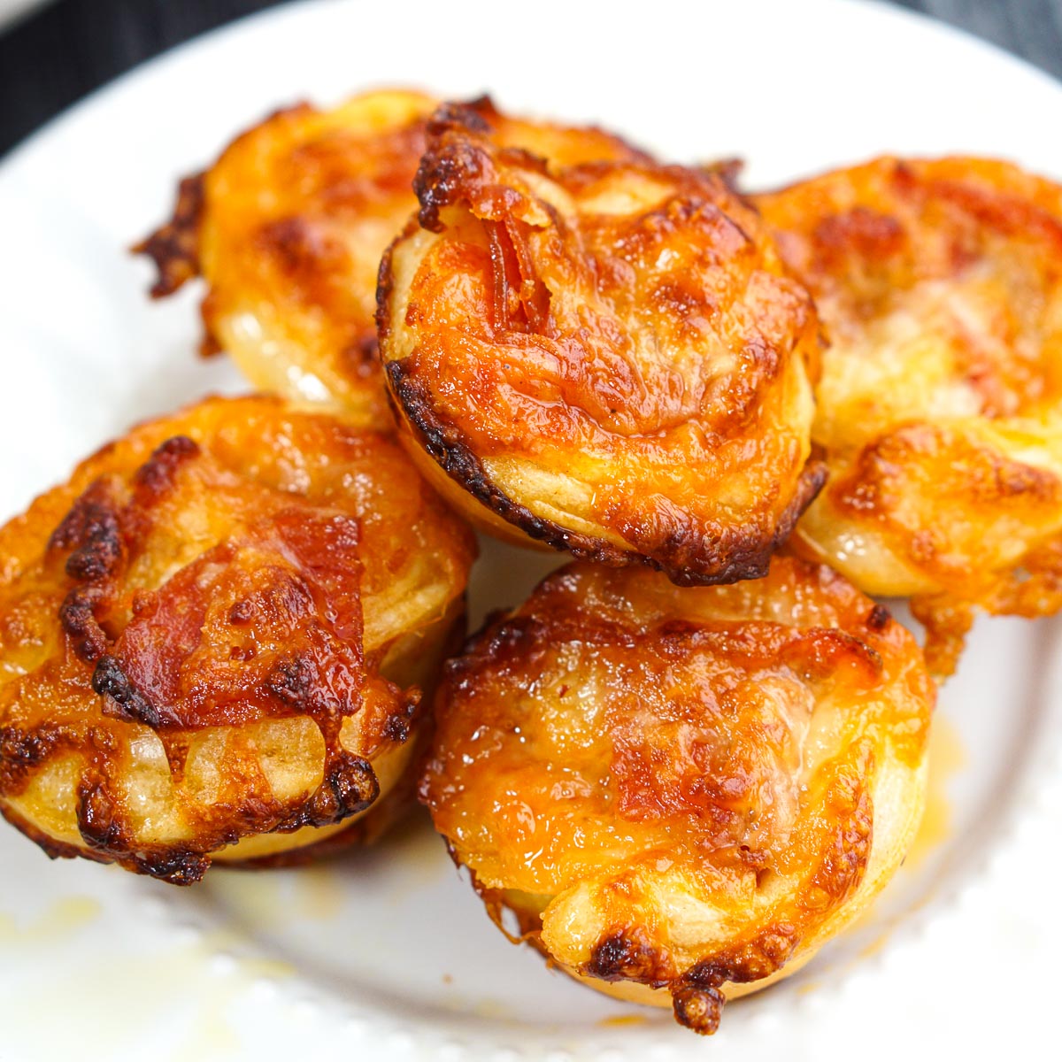 closeup of white plate with mini pizza muffins