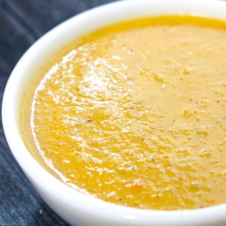 Closeup of a white bowl with the creamy sunchoke soup.