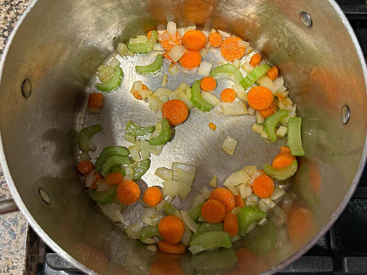 Pot with sautéed carrots and celery.