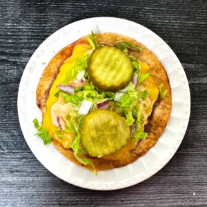 White plate with a keto Big Mac smash burger taco.
