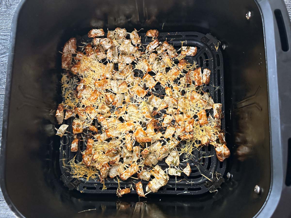Air fryer basket with the finished side dish.