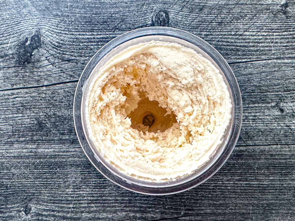 A Ninja Creami container with the finished vanilla protein ice cream.