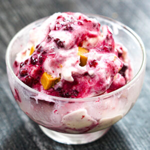 Closeup of a glass dessert dish with peanut butter and jelly protein ice cream made in the Ninja Creami.