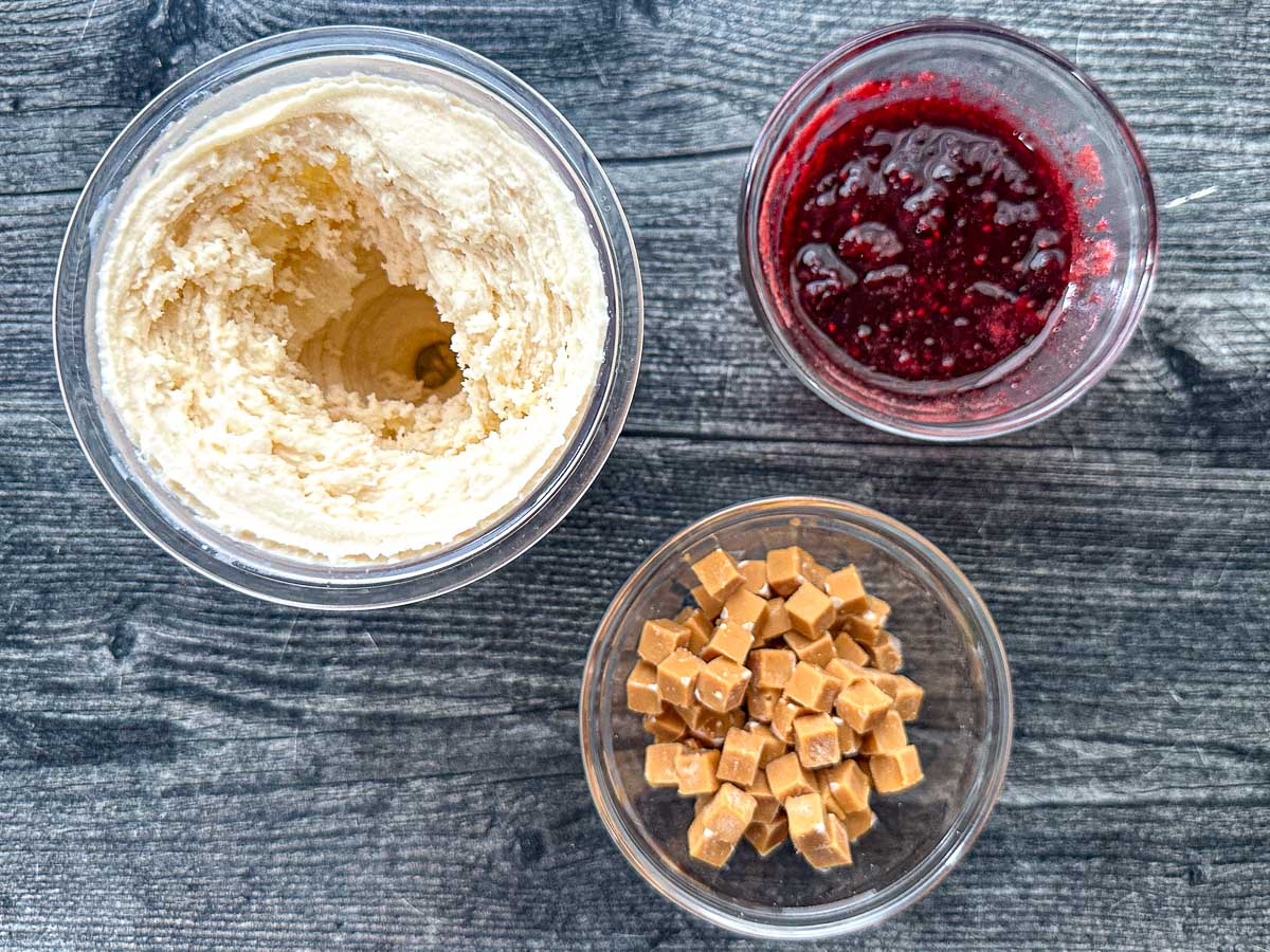 Aerial view of the finished Ninja Creami ice cream and the berry sauce and pb pieces.