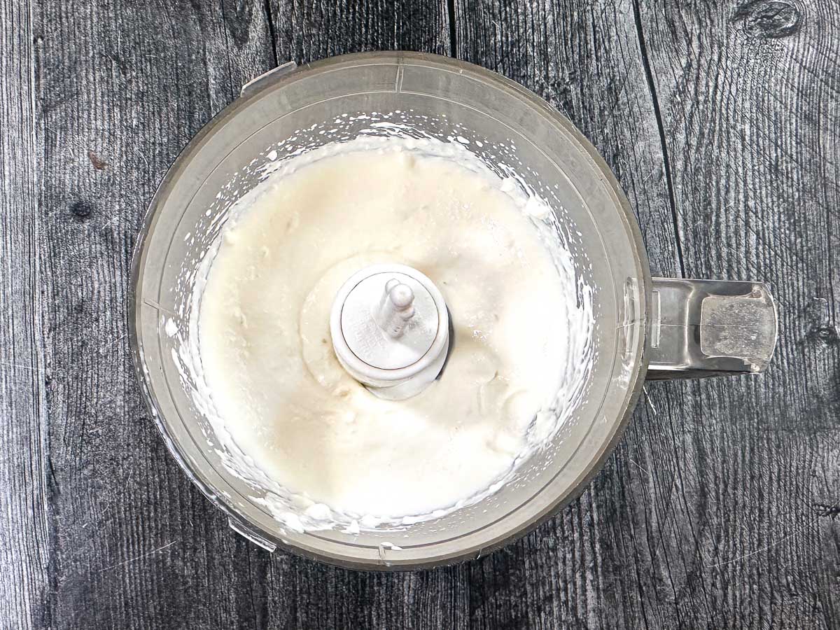 Food processor bowl with whipped cottage cheese.
