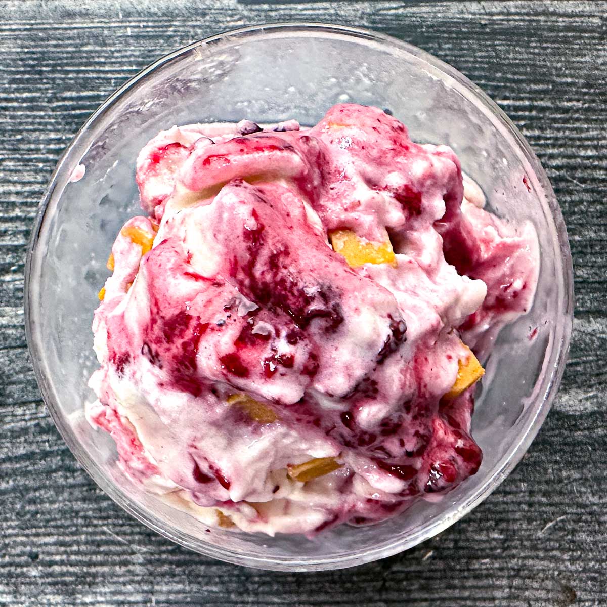 Aerial shot of a glass dessert dish with peanut butter and jelly protein ice cream made in the Ninja Creami.