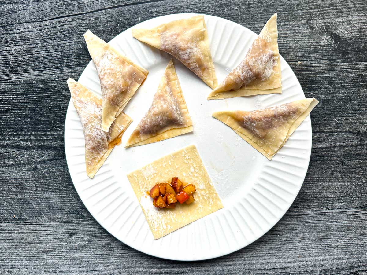 White plate with uncooked dessert wontons ready to bake.