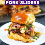 Closeup of a white plate with a bbq slider with a tray of them in the background and text.