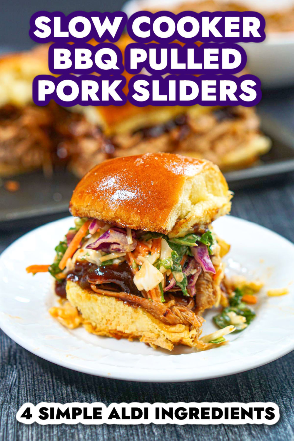 Closeup of a white plate with a bbq slider with a tray of them in the background and text.