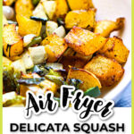 Close up of a white bowl with air fry delicata squash with peppers and onions and text overlay.