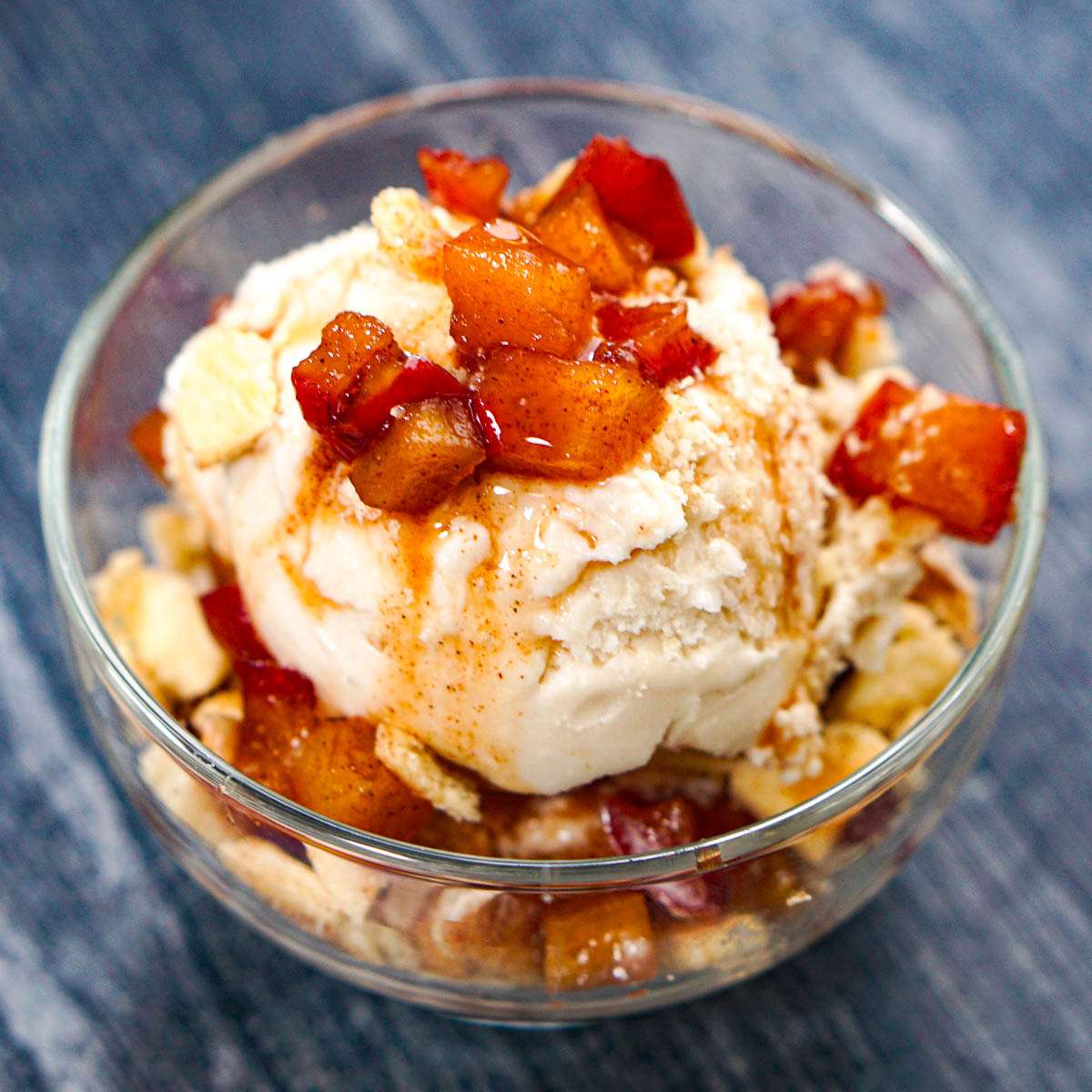 Closeup of a dessert cup with low carb Ninja Creami apple pie ice cream with diced cinnamon apples and pie crust crumbles.