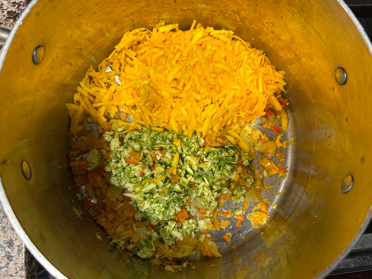 A stock pot with chopped veggies sautéing.