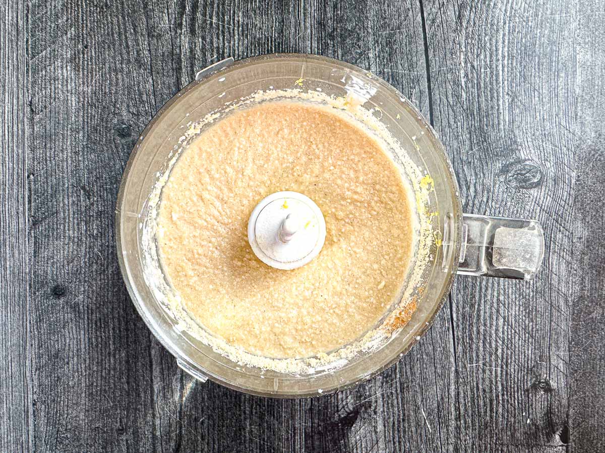 Food processor bowl with the muffin batter mixture before adding blueberries.