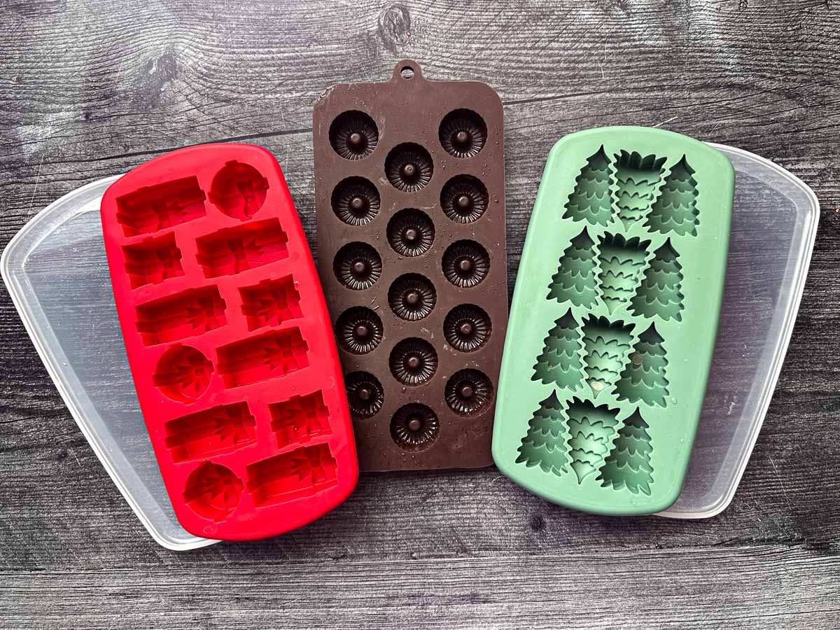3 silicone molds - one with presents, one with Christmas trees and one with round lifesaver looking molds.
