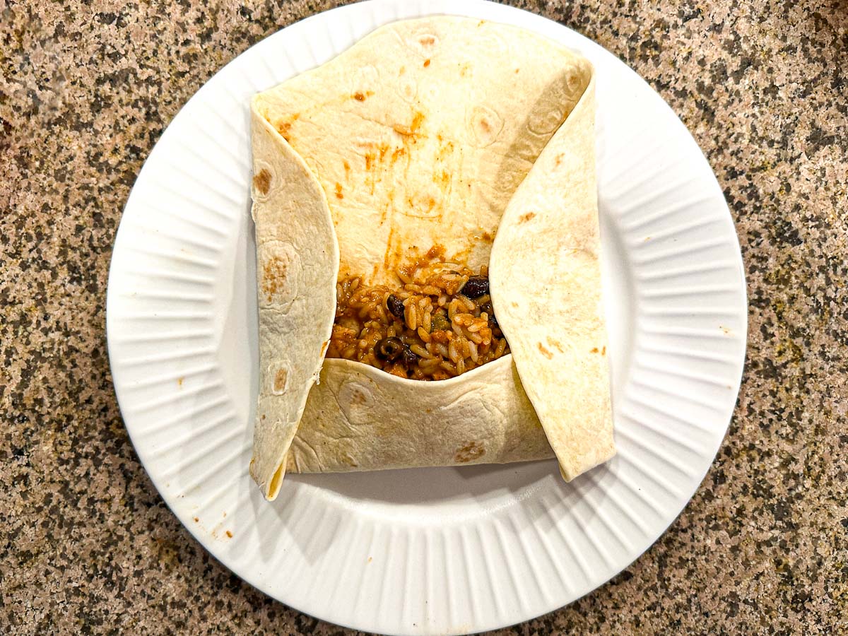 White plate showing how to wrap the meal plan burritos.