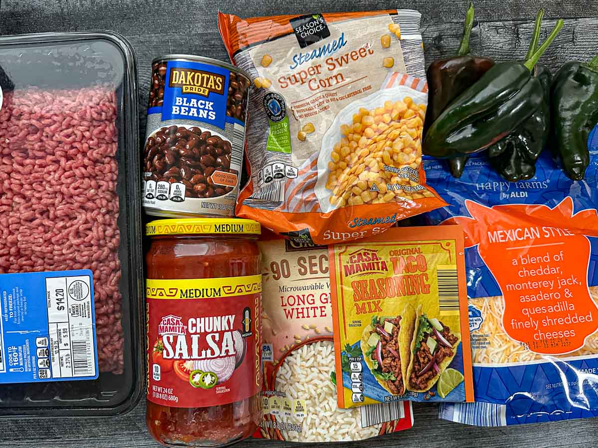 Recipe ingredients - black beans, ground beef, salsa, taco mix, rice, corn, mexican cheese, fresh poblano peppers.