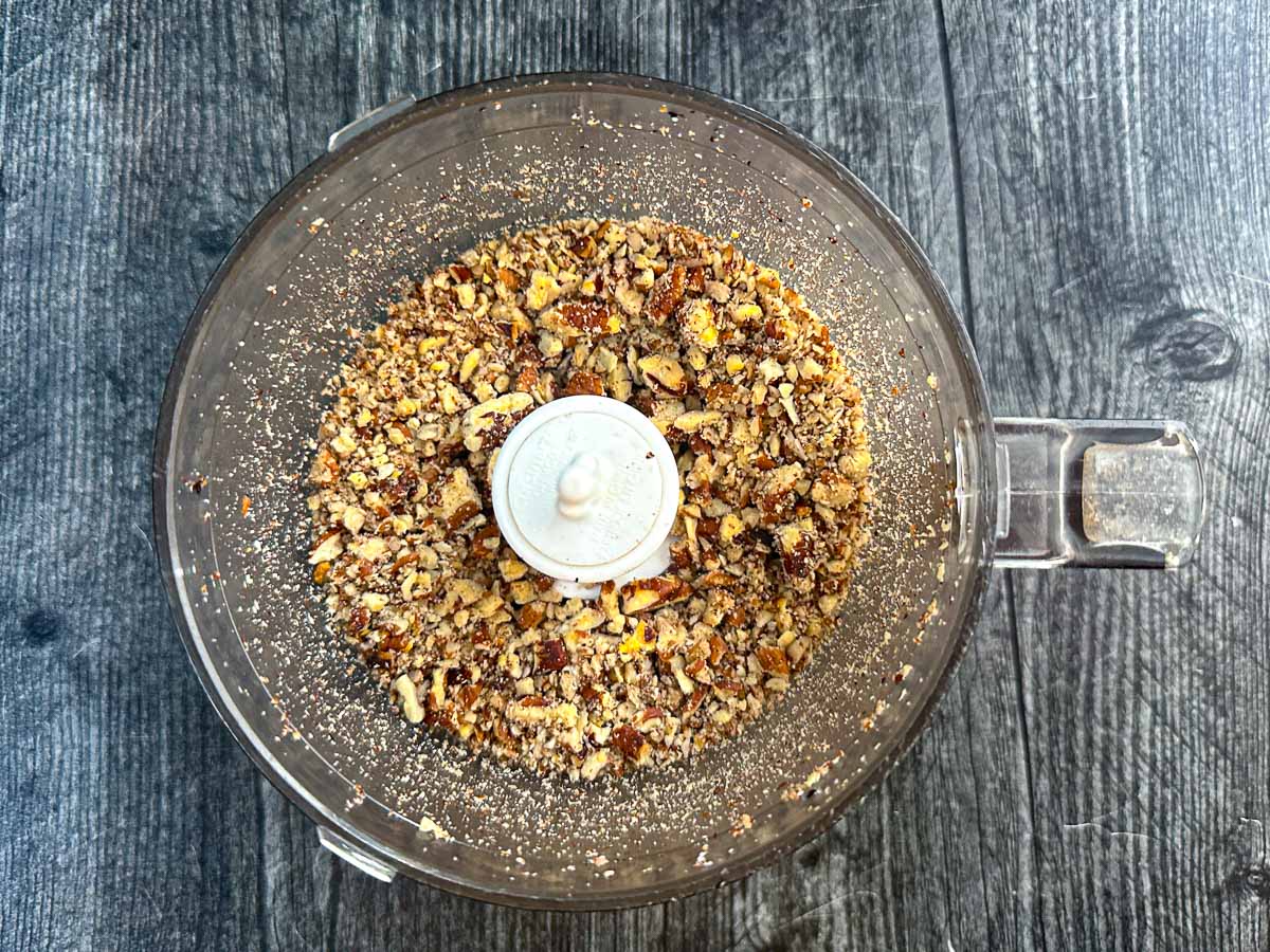 Food processor with chopped pecans.