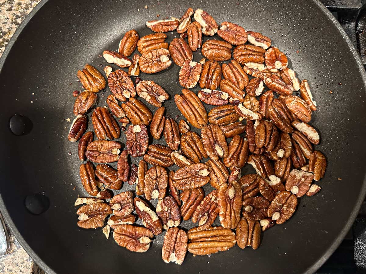 Pan with toasted pecan halves.