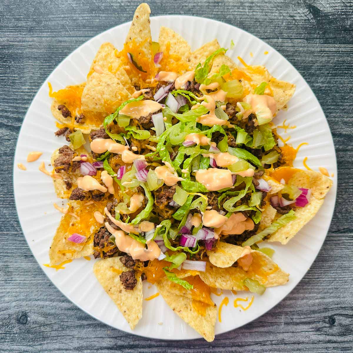 Aerial view of a white plate with the Big Mac nachos.