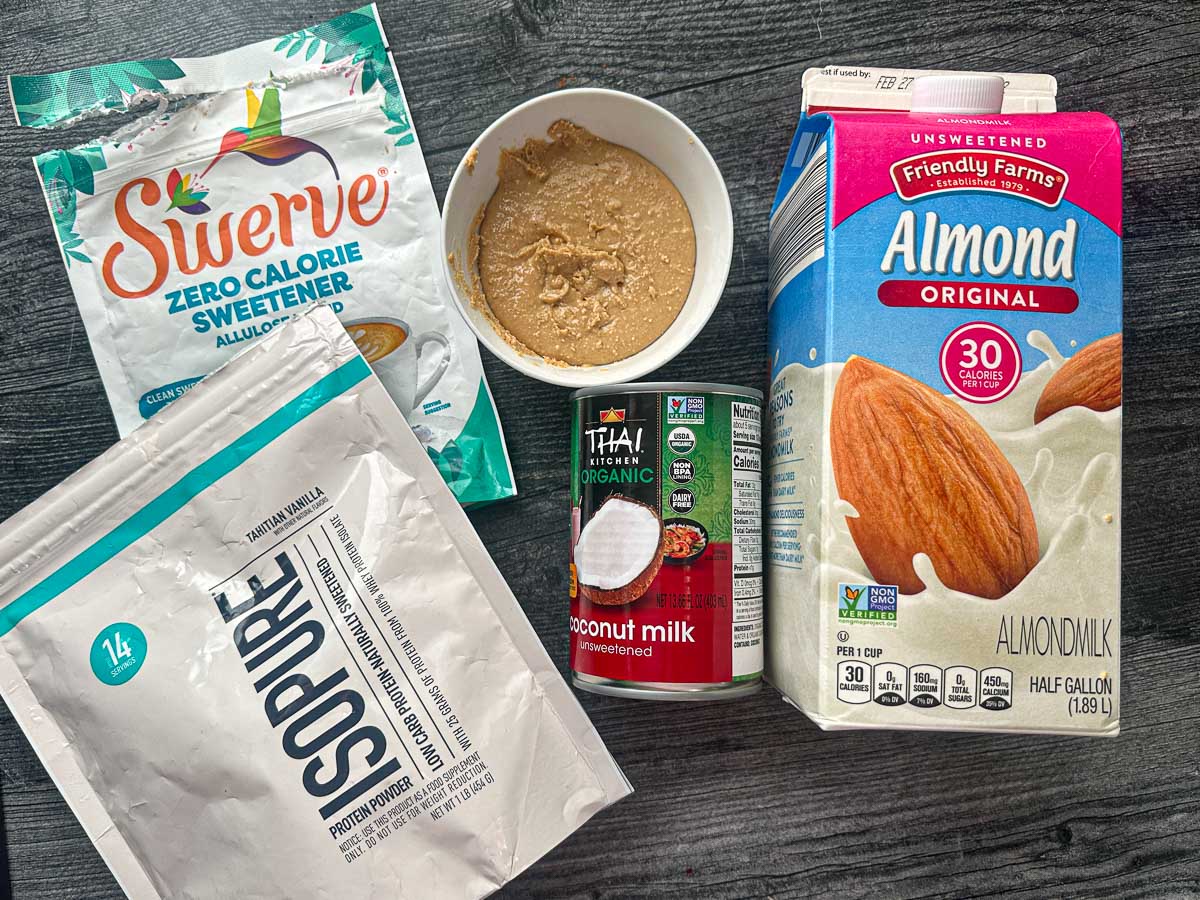 Recipe ingredients - almond milk, coconut milk, cashew butter, vanilla protein powder, and sweetener.