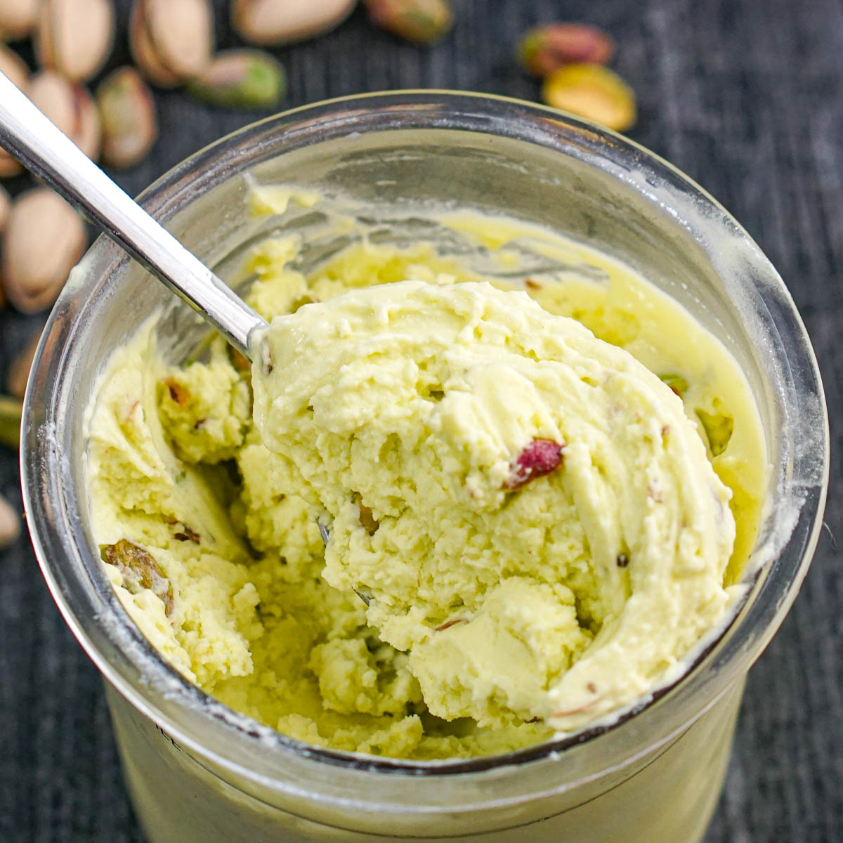 Closeup of a pint container with low carb high protein pistachio ice cream made in the Ninja Creami machine.