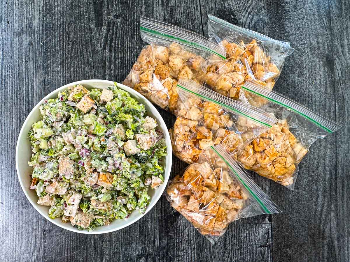 Baggies of cooked cubed chicken and a salad with some used in it.