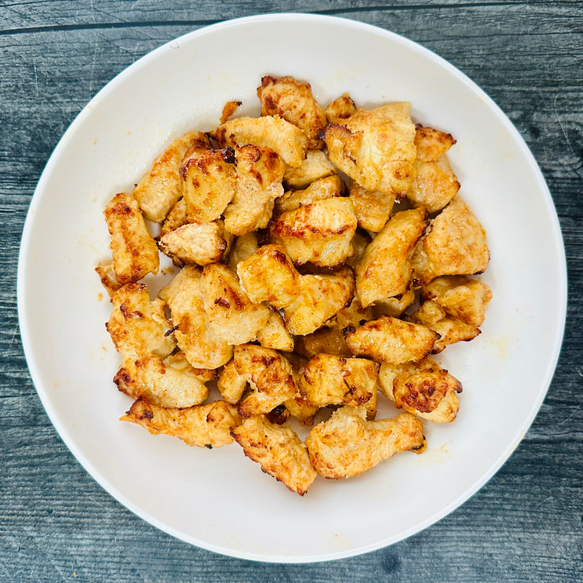 White bowl with the air fryer yogurt chicken marinade bites used for meal prep. 
