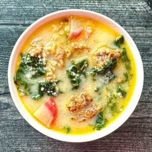 White bowl with keto cuppa Toscana soup.