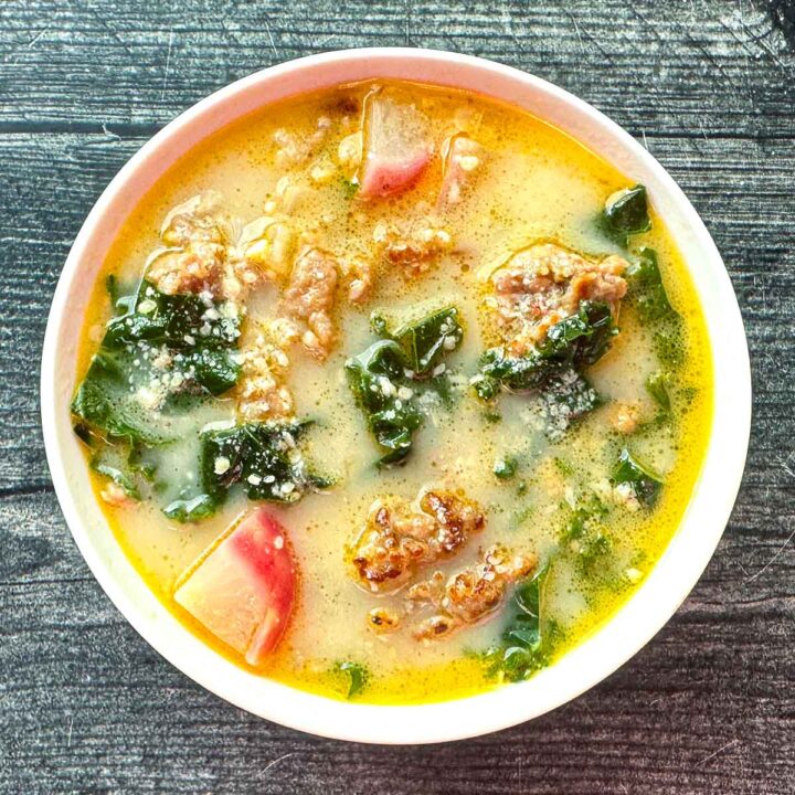 White bowl with keto cuppa Toscana soup.