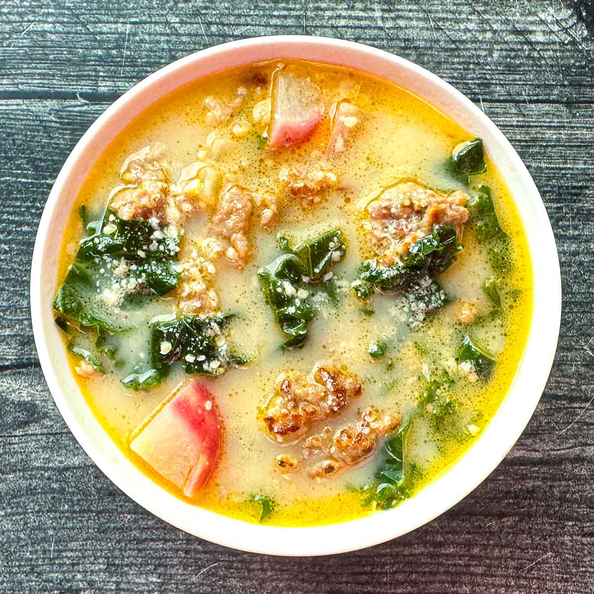 White bowl with keto cuppa Toscana soup.