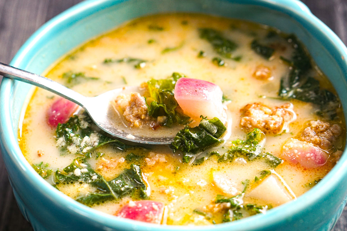Closeup of a spoonful of keto Zuppa Toscana soup.
