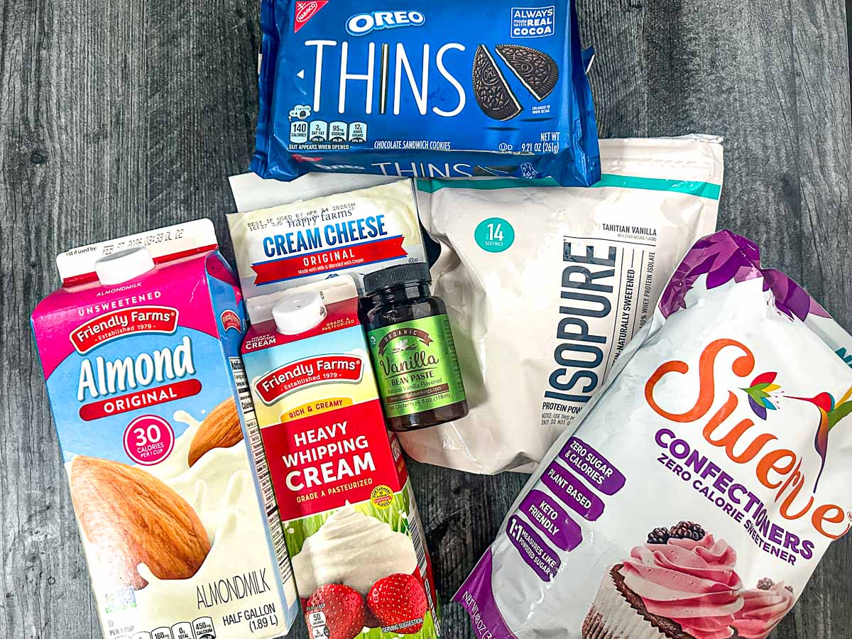 Recipe ingredients - almond milk, heavy cream, protein powder, oreo thins, vanilla, sweetener, cream cheese.