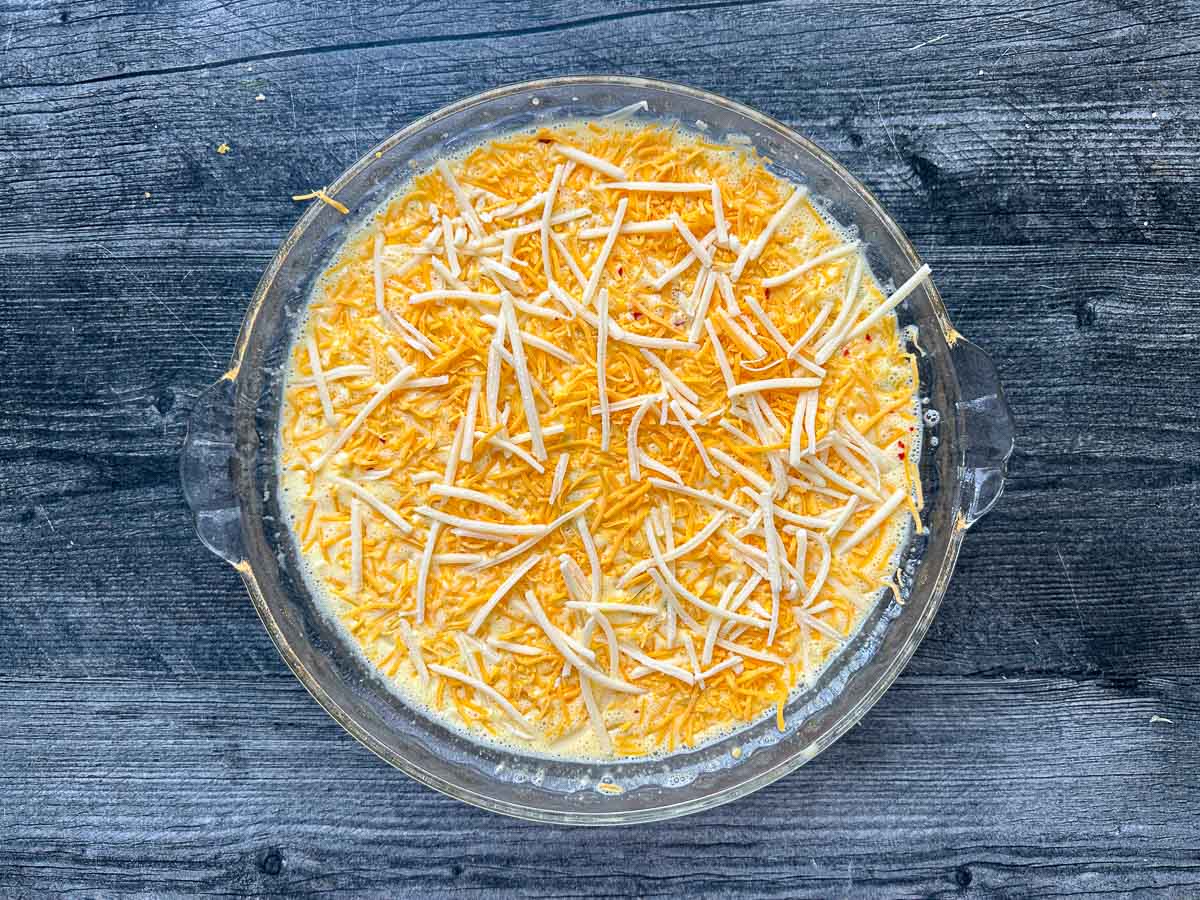 Pie pan with the quiche ready to go in the oven.