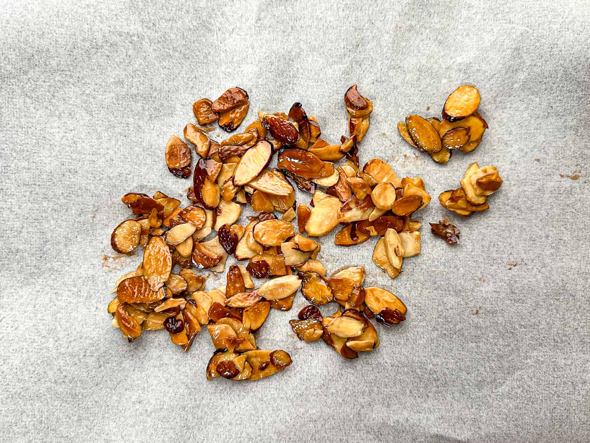 Parchment paper with toasted sugared almond slivers.