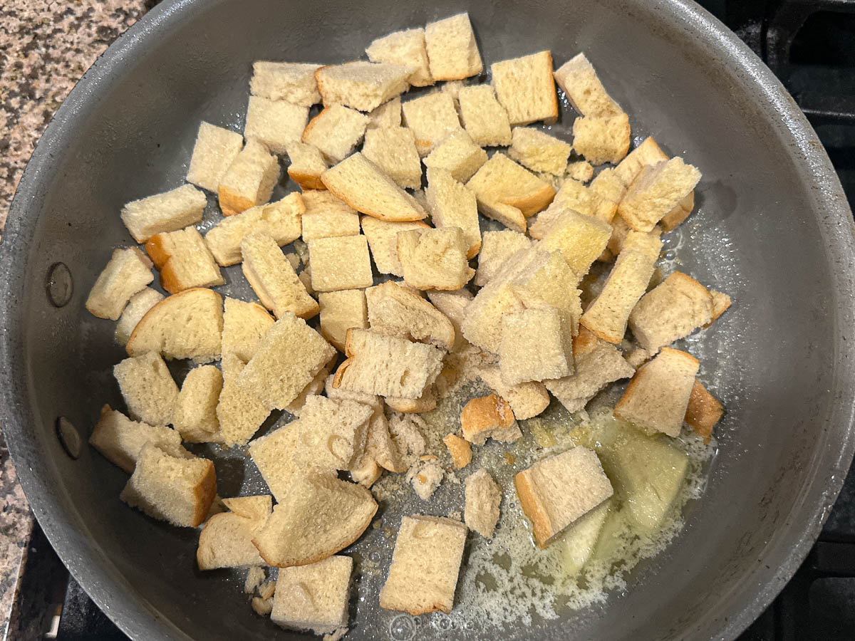 Pan with melted butter and stale keto bread cubes.
