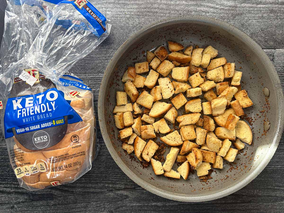 Pan with toasted keto croutons and a bag of keto bread.