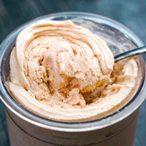 Closeup of a container of Ninja Creami strawberry cheesecake ice cream that's low carb and sugar free.